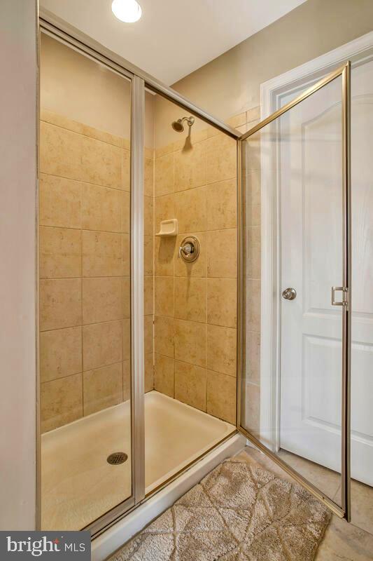 full bath with a shower stall