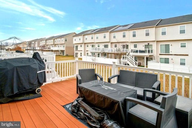 deck with grilling area, outdoor lounge area, and a residential view