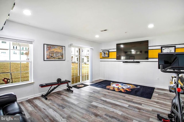 exercise room featuring recessed lighting, visible vents, baseboards, and wood finished floors