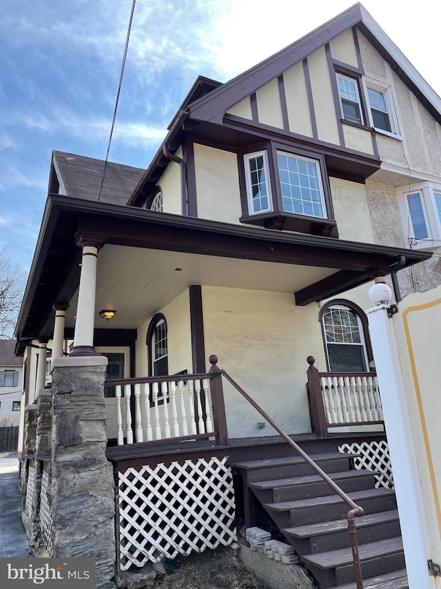 view of front of house featuring stucco siding and covered porch