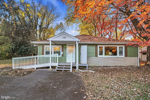 view of front of house featuring stone siding and covered porch