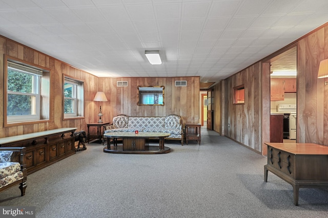 living room featuring visible vents and wood walls