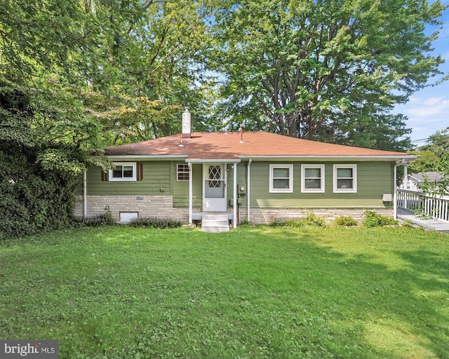 single story home with a chimney and a front yard