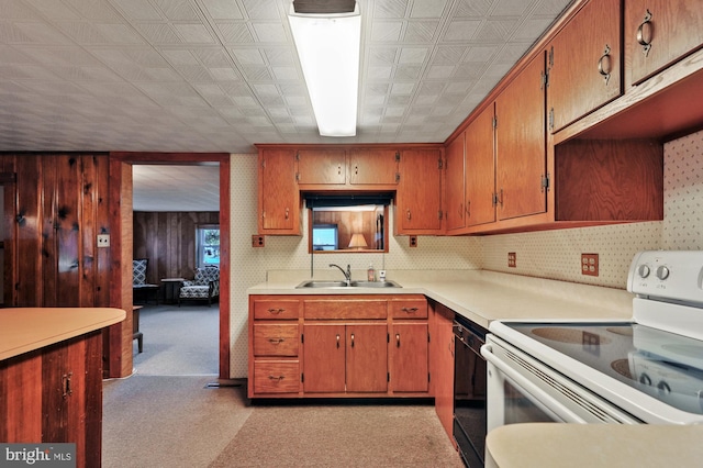 kitchen with dishwasher, white electric range oven, light countertops, and a sink