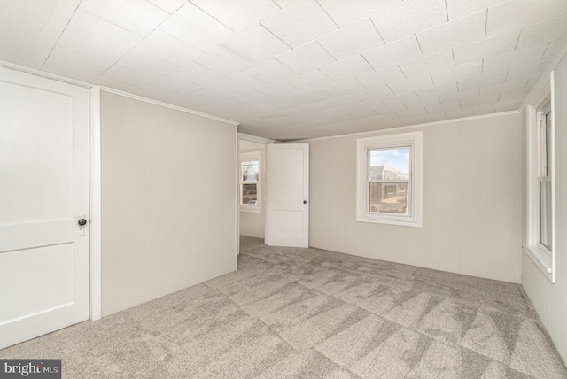 carpeted spare room with ornamental molding