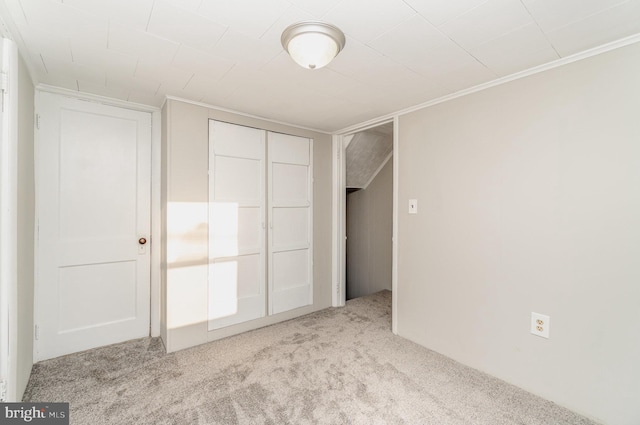 unfurnished bedroom featuring a closet and carpet