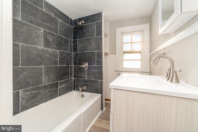 full bathroom with vanity, wood finished floors, and shower / bathtub combination