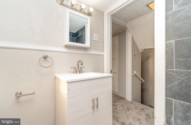 bathroom with vanity and a wainscoted wall