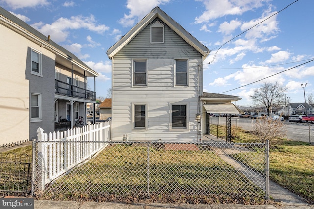 view of front of home featuring a front lawn and fence private yard