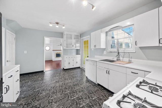 kitchen with white appliances, light countertops, and white cabinetry