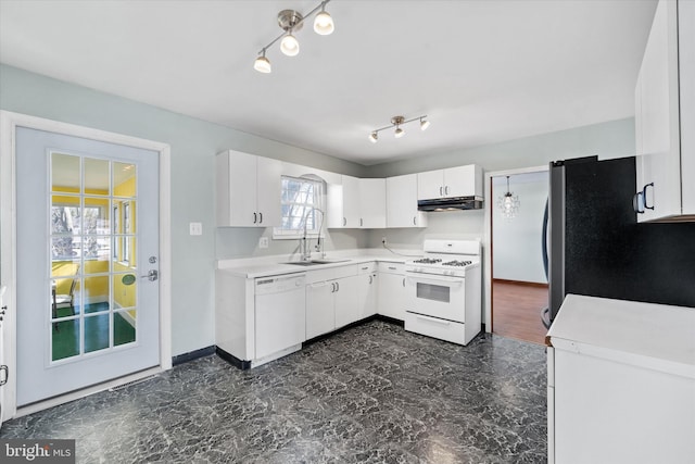 kitchen featuring under cabinet range hood, white cabinetry, white appliances, rail lighting, and light countertops