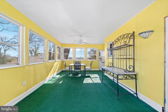 sunroom / solarium with a ceiling fan