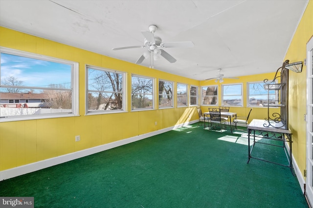 unfurnished sunroom with a ceiling fan