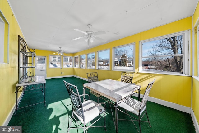 sunroom featuring a ceiling fan