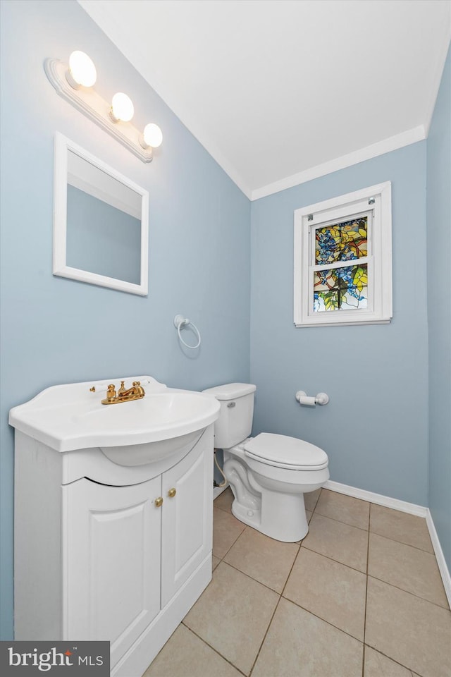 bathroom with tile patterned floors, toilet, and ornamental molding