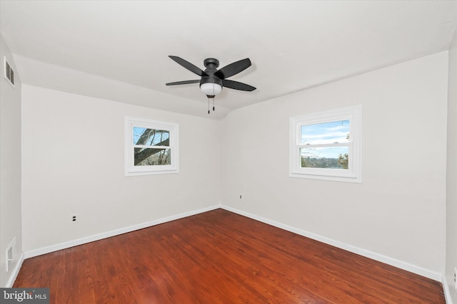 unfurnished room featuring a wealth of natural light, baseboards, and dark wood-style flooring