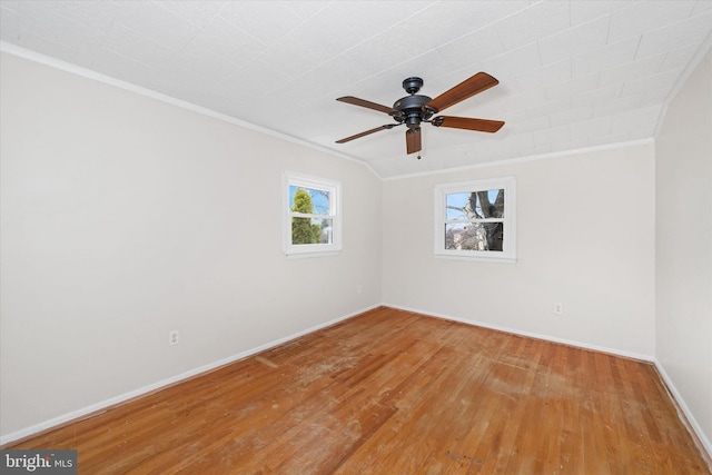 unfurnished room with baseboards, wood finished floors, a ceiling fan, and ornamental molding