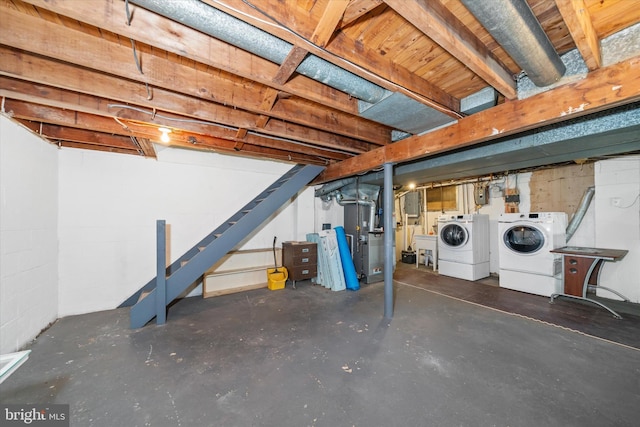 unfinished basement with stairs and separate washer and dryer