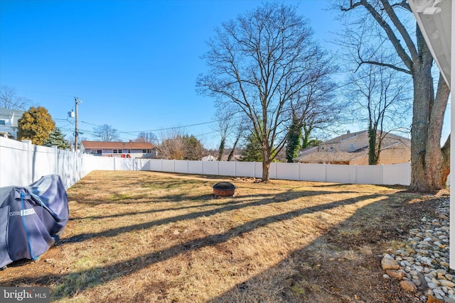 view of yard with an outdoor fire pit and a fenced backyard