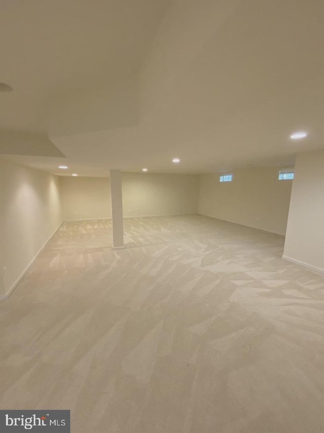 below grade area featuring recessed lighting and light colored carpet