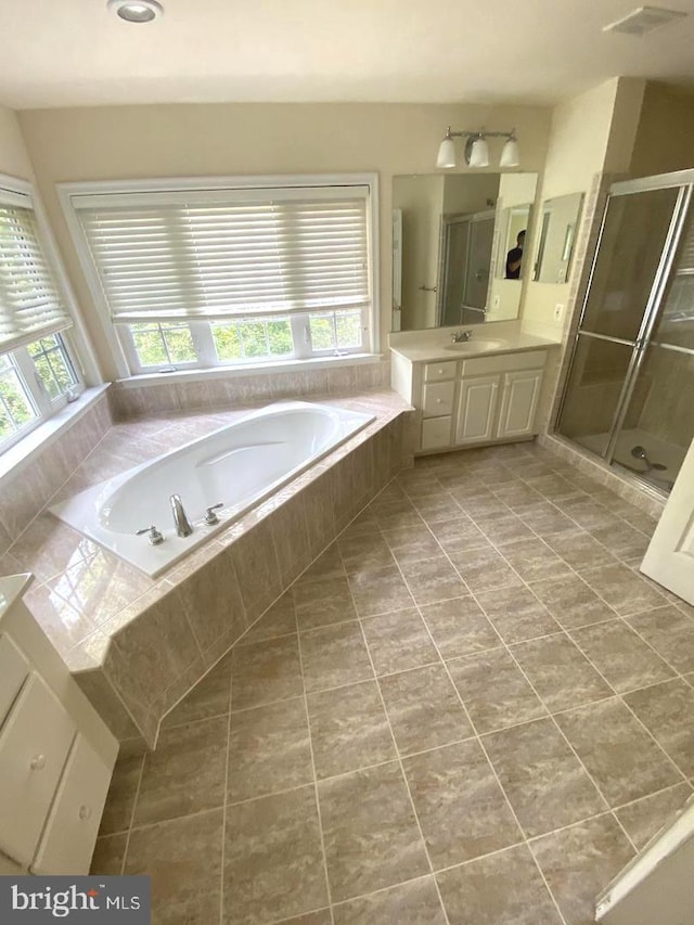 full bathroom with visible vents, a shower stall, a garden tub, tile patterned floors, and vanity