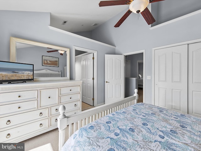 bedroom featuring visible vents, lofted ceiling, a closet, and carpet flooring