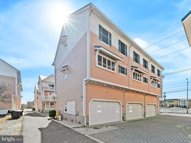 view of side of home featuring an attached garage