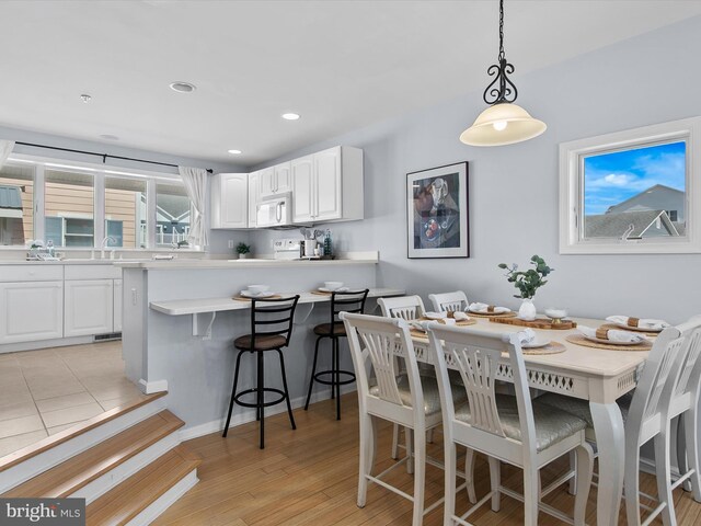 dining area featuring recessed lighting and light wood-type flooring