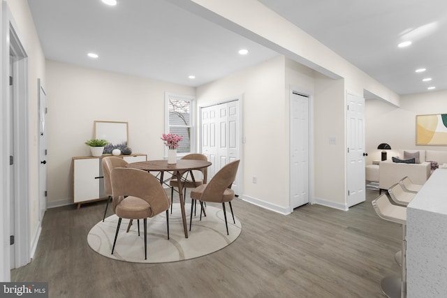 dining room featuring recessed lighting, baseboards, and wood finished floors