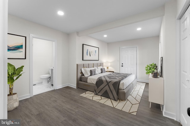 bedroom with recessed lighting, baseboards, wood finished floors, and ensuite bathroom