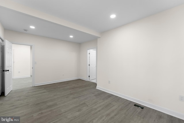 unfurnished room with recessed lighting, baseboards, and wood finished floors