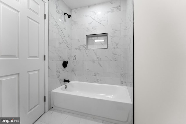 full bath featuring marble finish floor and  shower combination