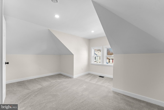 additional living space featuring visible vents, recessed lighting, carpet floors, baseboards, and vaulted ceiling