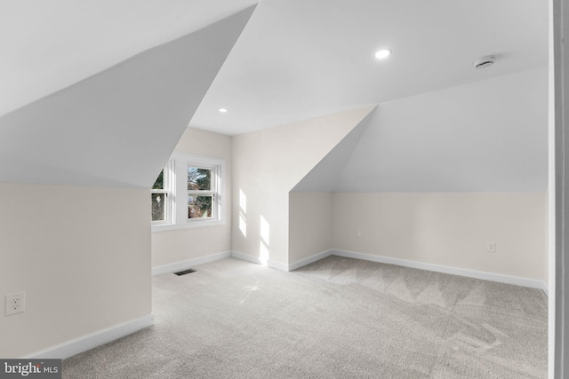 bonus room with vaulted ceiling, baseboards, visible vents, and carpet floors