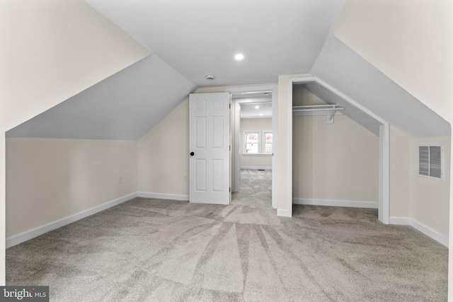 bonus room with visible vents, carpet floors, baseboards, and vaulted ceiling