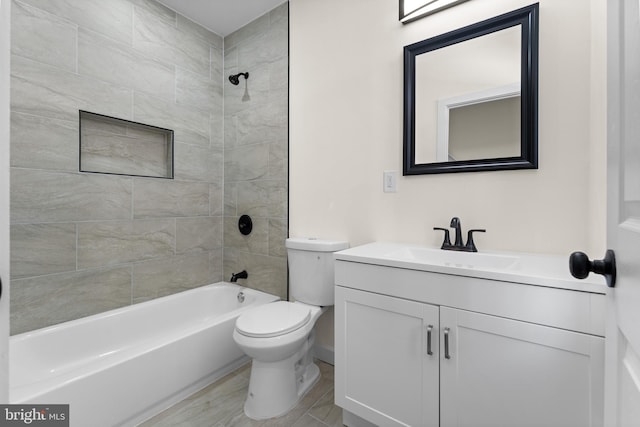 full bath featuring toilet, bathtub / shower combination, and vanity