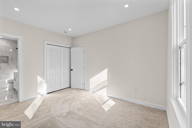 unfurnished bedroom with carpet flooring, recessed lighting, baseboards, and connected bathroom