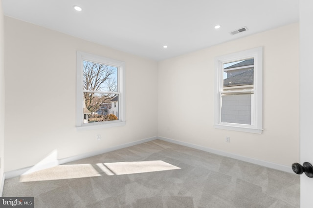 unfurnished room with carpet flooring, recessed lighting, and visible vents