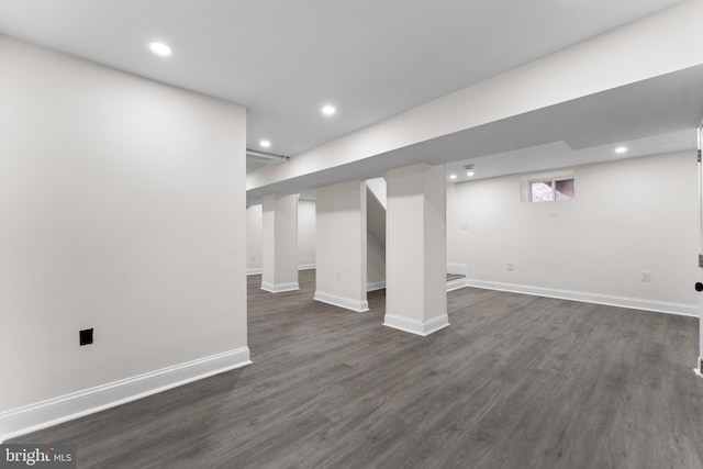 below grade area featuring recessed lighting, baseboards, and dark wood-type flooring