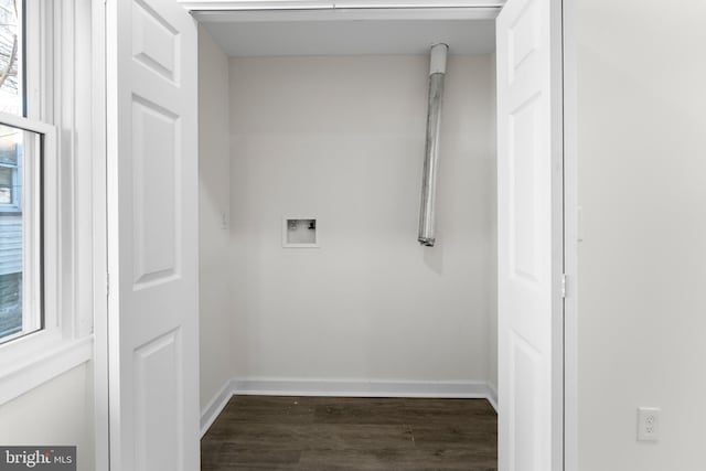 clothes washing area with dark wood-style floors, laundry area, hookup for a washing machine, and baseboards