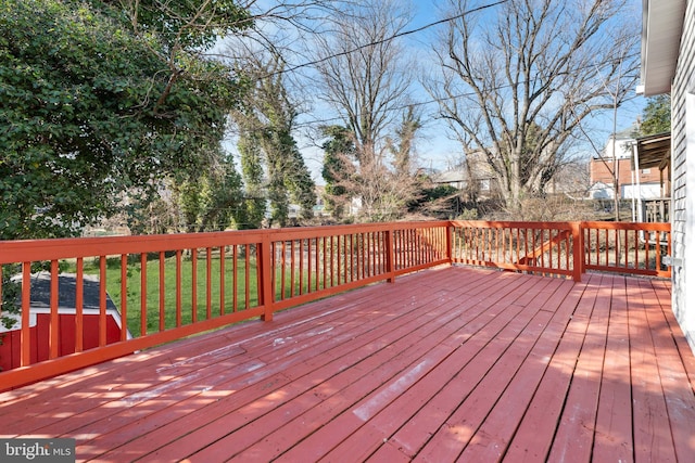 wooden terrace with a lawn