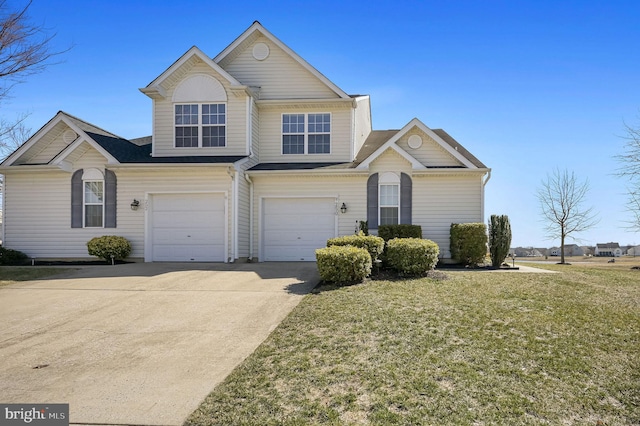 view of front of home featuring a garage, a front yard, and driveway