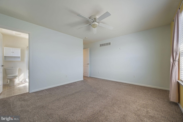 unfurnished bedroom with a ceiling fan, baseboards, visible vents, carpet flooring, and connected bathroom