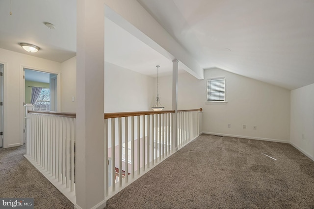 additional living space with baseboards, lofted ceiling, and carpet floors