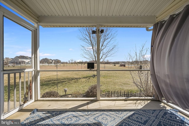 unfurnished sunroom featuring a rural view