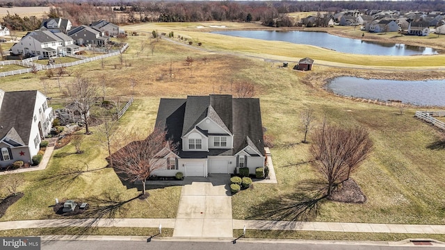 birds eye view of property with a water view and a residential view