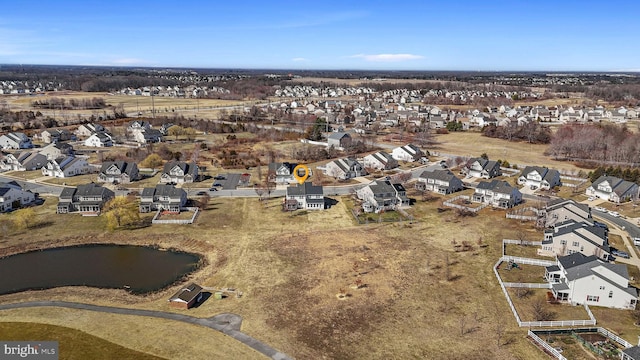 drone / aerial view featuring a residential view and a water view