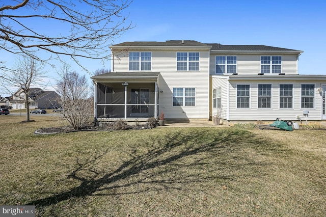 rear view of property with a lawn and a sunroom