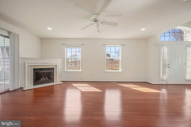 unfurnished living room featuring a fireplace with flush hearth, wood finished floors, recessed lighting, and ceiling fan