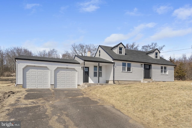 cape cod house with a garage, roof with shingles, and aphalt driveway